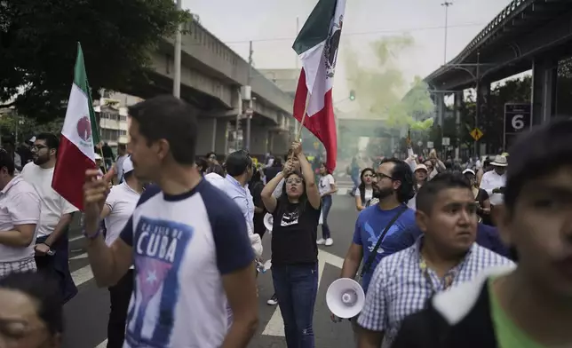 Law students block a street to protest against constitutional reform proposals that would make judges stand for election, outside a sports center where lawmakers are meeting as an alternative due to other demonstrators blocking Congress in Mexico City, Tuesday, Sept. 3, 2024. (AP Photo/Felix Marquez)