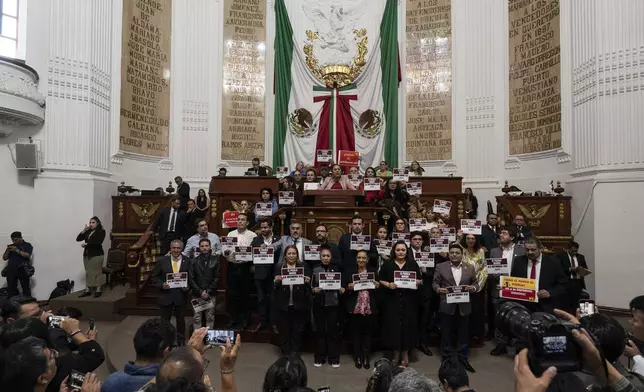 Mexico City legislators in favor of judicial reform pose for photos at the Mexico City Congress, Thursday, Sept. 12, 2024. (AP Photo/Felix Marquez)