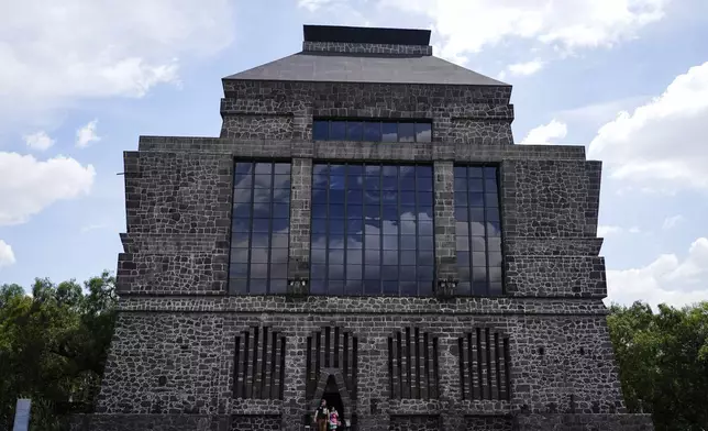 Visitors exit the Anahuacalli Museum in Mexico City, Tuesday, Aug. 20, 2024. Built by Mexican artist Diego Rivera, its name, Anahuacalli, translates from the Nahuatl language as "house surrounded by water." (AP Photo/Eduardo Verdugo)