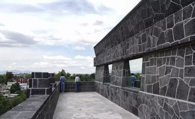 Visitors look out from the exterior of the Anahuacalli Museum in Mexico City, Tuesday, Aug. 20, 2024. Built by Mexican artist Diego Rivera, its name, Anahuacalli, translates from the Nahuatl language as "house surrounded by water." (AP Photo/Eduardo Verdugo)