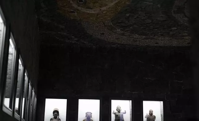 A visitor takes a photo of a ceiling mosaic in the Anahuacalli Museum in Mexico City, Tuesday, Aug. 20, 2024. Built by Mexican artist Diego Rivera to preserve and display his lifelong collection of pre-Hispanic art, the museum is celebrating its 60th anniversary. (AP Photo/Eduardo Verdugo)