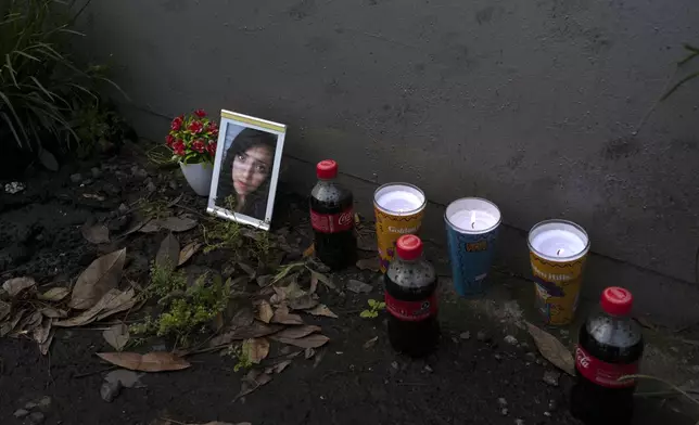 A portrait of Karen Flores adorns a makeshift memorial outside Álvaro Obregón 286 felled by the 2017 earthquake, during the annual seismic drill that marks the anniversary date of the 1985 and 2017 deadly quakes, in Mexico City, Thursday, Sept. 19, 2024. (AP Photo/Jon Orbach)