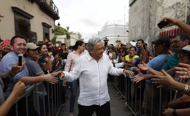 FILE - Mexican President-elect Andres Manuel Lopez Obrador greets supporters as he kicks off a nationwide tour after his election in Mazatlan, Mexico, Sept. 16, 2018. (AP Photo/Eduardo Verdugo, File)