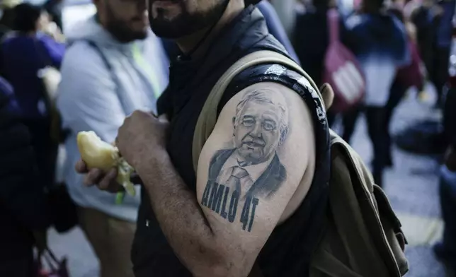 FILE - A supporter of Mexican President Andres Manuel Lopez Obrador sporting a tattoo of the president arrives for a march to show support for Lopez Obrador's administration in Mexico City, Nov. 27, 2022. (AP Photo/Eduardo Verdugo, File)