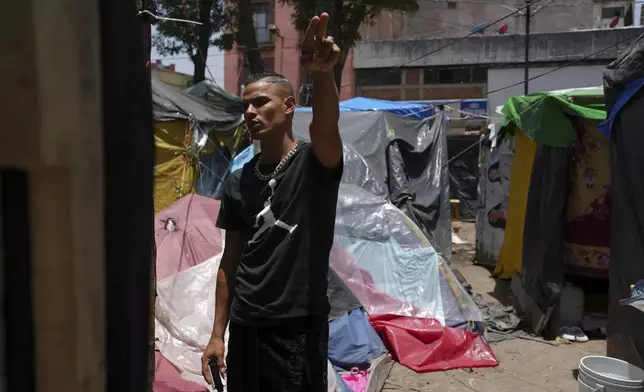 Venezuelan migrant Hector Magallanes, who has been waiting months for a CBP One appointment, has set up a task force to oversee security and infrastructure at a migrant tent encampment on the plaza of the Santa Cruz y La Soledad Catholic parish church, in La Merced neighborhood of Mexico City, Monday, July 8, 2024. (AP Photo/Marco Ugarte)