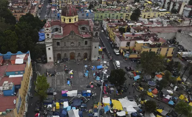 FILE - An aerial view of a migrant tent encampment set up on the plaza of the Santa Cruz y La Soledad Catholic parish church, in La Merced neighborhood of Mexico City, Dec. 26, 2023. (AP Photo/Marco Ugarte, File)