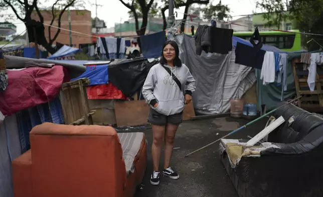 Migrant Carolina Arriaga stands in a migrant tent encampment in Mexico City, Thursday, June 27, 2024. (AP Photo/Marco Ugarte)