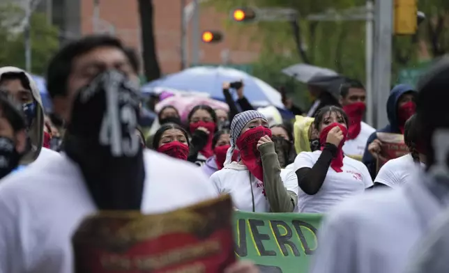 Families and friends take part in a demonstration marking the 10-year anniversary of the disappearance of 43 students from an Ayotzinapa rural teacher's college, in Mexico City, Thursday, Sept. 26, 2024. (AP Photo/Fernando Llano)