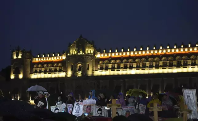 Families and friends gather outside the National Palace during a demonstration marking the 10-year anniversary of the disappearance of 43 students from an Ayotzinapa rural teacher's college, in Mexico City, Thursday, Sept. 26, 2024. (AP Photo/Fernando Llano)