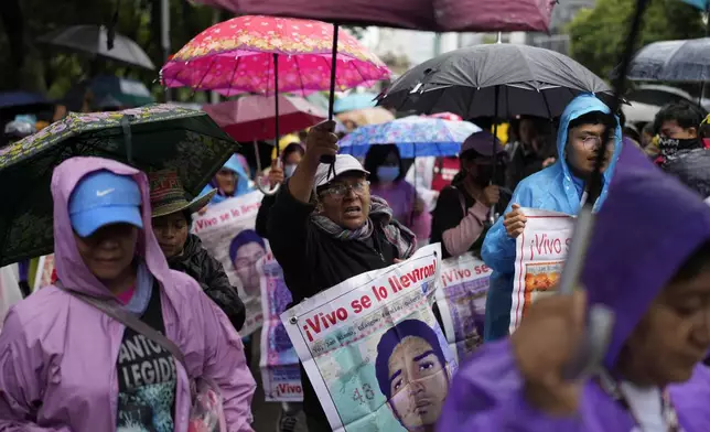 Families and friends take part in a demonstration marking the 10-year anniversary of the disappearance of 43 students from an Ayotzinapa rural teacher's college, in Mexico City, Thursday, Sept. 26, 2024. (AP Photo/Eduardo Verdugo)