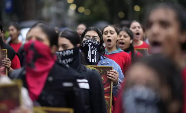 Families and friends take part in a demonstration marking the 10-year anniversary of the disappearance of 43 students from an Ayotzinapa rural teacher's college, in Mexico City, Thursday, Sept. 26, 2024. (AP Photo/Eduardo Verdugo)