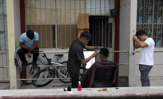 Students cut each other's hair at the Raúl Isidro Burgos Rural Normal School in Ayotzinapa, Guerrero state, Mexico, Monday, Aug. 19, 2024. (AP Photo/Marco Ugarte)