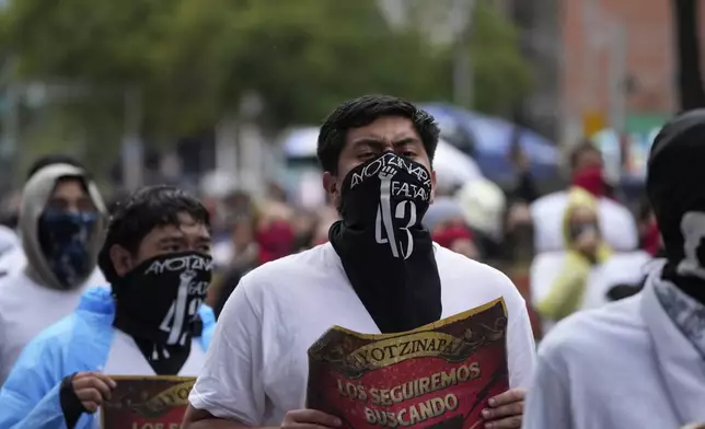 Families and friends take part in a demonstration marking the 10-year anniversary of the disappearance of 43 students from an Ayotzinapa rural teacher's college, in Mexico City, Thursday, Sept. 26, 2024. (AP Photo/Fernando Llano)