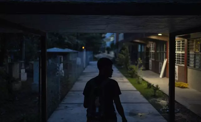 A student walks on the campus of the Raúl Isidro Burgos Rural Normal School in Ayotzinapa, Guerrero state, Mexico, late Sunday, Aug. 25, 2024. (AP Photo/Felix Marquez)