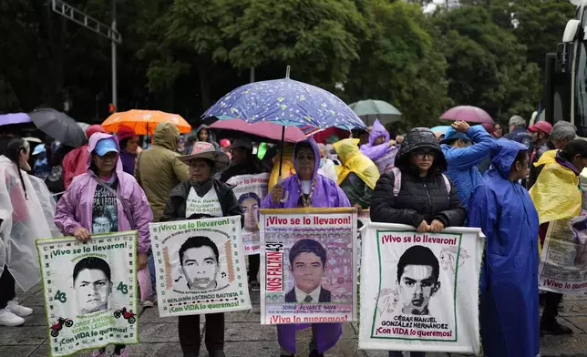 Families and friends take part in a demonstration marking the 10-year anniversary of the disappearance of 43 students from an Ayotzinapa rural teacher's college, in Mexico City, Thursday, Sept. 26, 2024. (AP Photo/Eduardo Verdugo)