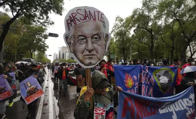 Families and friends take part in a demonstration marking the 10-year anniversary of the disappearance of 43 students from an Ayotzinapa rural teacher's college, in Mexico City, Thursday, Sept. 26, 2024. (AP Photo/Fernando Llano)