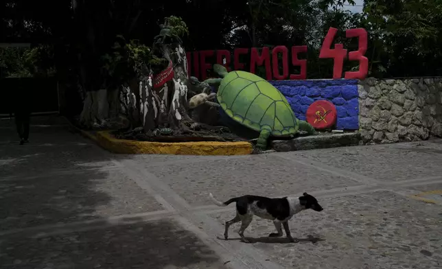 The entrance of the Raúl Isidro Burgos Rural Normal School features a turtle and the words "We want the 43," referring to the number of students who went missing 10 years ago, in Ayotzinapa, Guerrero state, Mexico, Monday, Aug. 19, 2024. Ayotzinapa means "The place of the turtles" in the Nahuatl Indigenous language. (AP Photo/Marco Ugarte)