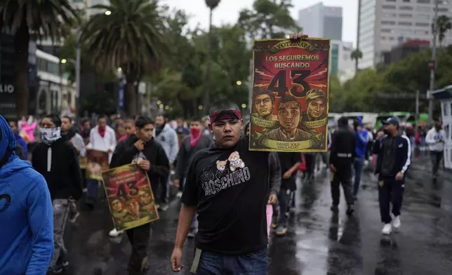 Families and friends take part in a demonstration marking the 10-year anniversary of the disappearance of 43 students from an Ayotzinapa rural teacher's college, in Mexico City, Thursday, Sept. 26, 2024. (AP Photo/Eduardo Verdugo)