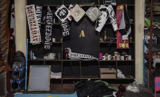 Political posters and stickers hang inside the print shop at the Raúl Isidro Burgos Rural Normal School in Ayotzinapa, Guerrero state, Mexico, Sunday, Aug. 25, 2024. (AP Photo/Felix Marquez)