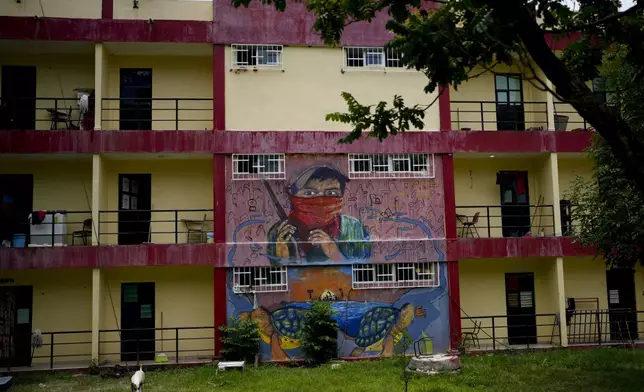 A mural covers the dormitories of the Raúl Isidro Burgos Rural Normal School in Ayotzinapa, Guerrero state, Mexico, Monday, Aug. 19, 2024. (AP Photo/Marco Ugarte)