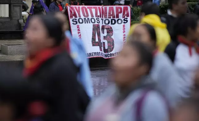 Families and friends take part in a demonstration marking the 10-year anniversary of the disappearance of 43 students from an Ayotzinapa rural teacher's college, in Mexico City, Thursday, Sept. 26, 2024. (AP Photo/Eduardo Verdugo)