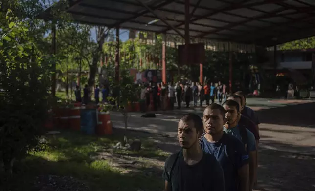 First-year students line up before starting cleanup work at the Raúl Isidro Burgos Rural Normal School in Ayotzinapa, Guerrero state, Mexico, Saturday, Aug. 24, 2024. (AP Photo/Felix Marquez)