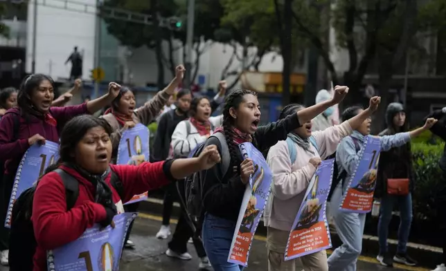 Youths take part in a demonstration marking the 10-year anniversary of the disappearance of 43 students from an Ayotzinapa rural teacher's college, in Mexico City, Thursday, Sept. 26, 2024. (AP Photo/Eduardo Verdugo)