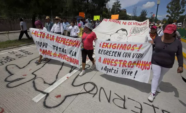 FILE - People protest the disappearance of 43 students from Raúl Isidro Burgos Rural Normal School and demand authorities find them, in Chilpancingo, Guerrero state, Mexico, Oct. 8, 2014. (AP Photo/Eduardo Verdugo, File)