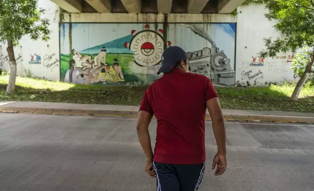 Ulises Martinez, a former student of the Raúl Isidro Burgos Rural Normal School, walks under the bridge where two of the buses that his missing classmates commandeered were attacked 10 years ago when he was a student there, in Iguala, Guerrero state, Mexico, Saturday, Sept. 7, 2024. (AP Photo/Felix Marquez)