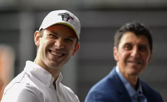 NASCAR driver Daniel Suarez, of Mexico, smiles alongside NASCAR Mexico Series CEO and President Jimmy Morales, during a press conference in Mexico City, Tuesday, Aug. 27, 2024. (AP Photo/Eduardo Verdugo)