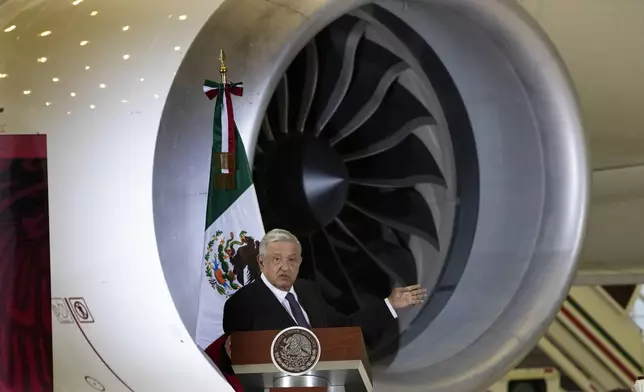 FILE - Mexican President Andres Manuel Lopez Obrador gives his daily, morning press conference in front of the former presidential plane at Benito Juarez International Airport in Mexico City, July 27, 2020. (AP Photo/Marco Ugarte, File)