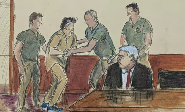 In this courtroom sketch, Ismael “El Mayo” Zambada, second left, assisted by the U.S. Marshals, is led into the courtroom as his defense attorney Frank Perez, seated right, watches in federal court, Friday, Sept. 13, 2024, in the Brooklyn borough of New York,. (Elizabeth Williams via AP)