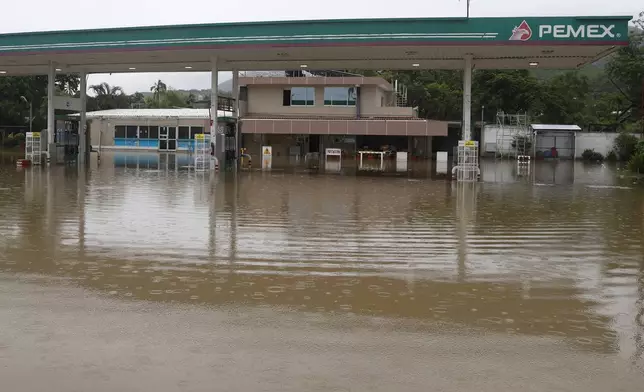 A gas station sits partially submerged by floodwaters in the aftermath of Hurricane John, in Acapulco, Mexico, Friday, Sept. 27, 2024. (AP Photo/Bernardino Hernandez)