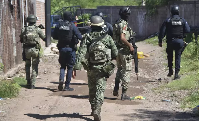 Soldiers and police arrive at the area where bodies lie on the ground in Culiacan, Sinaloa state, Mexico, Tuesday, Sept. 17, 2024. (AP Photo)