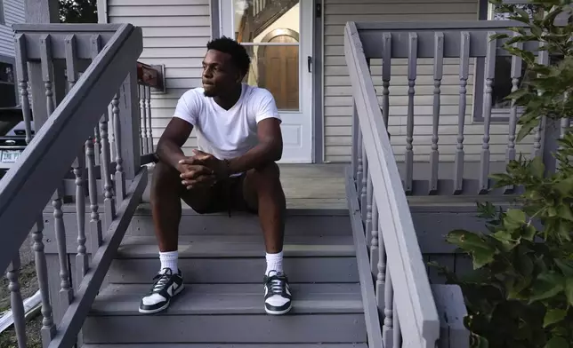 Armorion Smith, an NCAA football player at Michigan State, sits on the steps at home in Lansing, Mich., Tuesday, Sept. 3, 2024. (AP Photo/Paul Sancya)