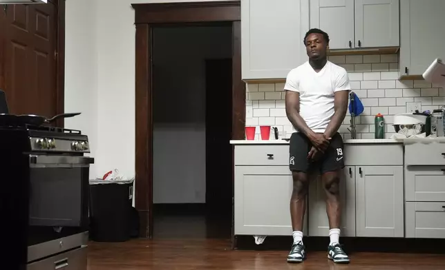 Armorion Smith, an NCAA football player at Michigan State, stands in his kitchen at home in Lansing, Mich., Tuesday, Sept. 3, 2024. (AP Photo/Paul Sancya)