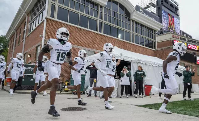 Michigan State defensive back Armorion Smith (19) takes the field with teammates before an NCAA college football game against Maryland, Saturday, Sept. 7, 2024, in College Park, Md. (AP Photo/Stephanie Scarbrough)