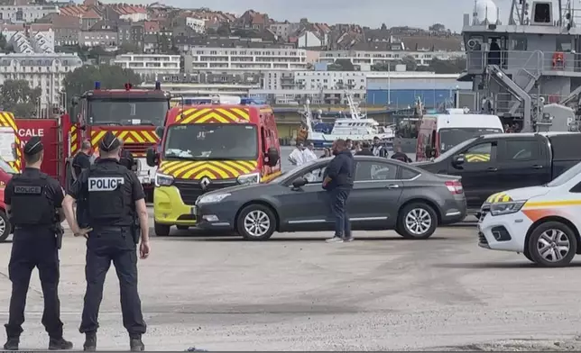 In this grab taken from video provided by BFM Littoral, emergency services at the port of Boulogne-Sur-Mer, France, Tuesday, Sept. 3, 2024, after a boat thought to be carrying migrants ripped apart attempting to cross the English Channel. (BFM Littoral via AP)