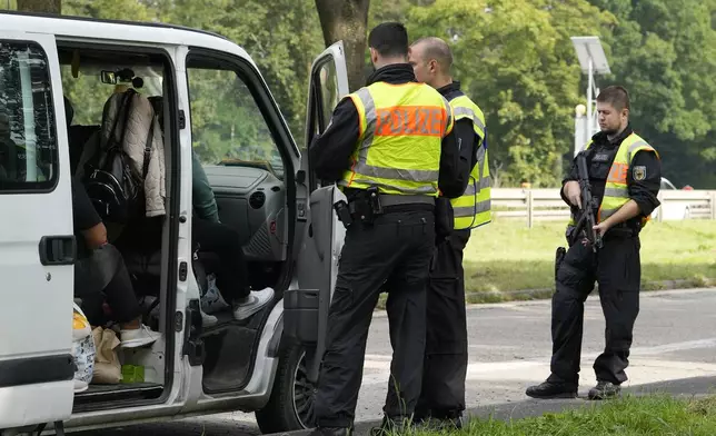 German police check the details of a van from Bulgaria near the border to Belgium in Aachen, Germany, Monday, Sept. 16, 2024, as Germany begins carrying out checks at all its land borders. (AP Photo/Martin Meissner)