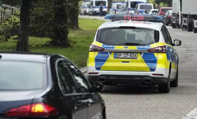 German police escort a French car to a control near the border to Belgium, in Aachen, Germany, Monday, Sept. 16, 2024, as Germany begins carrying out checks at all its land borders. (AP Photo/Martin Meissner)