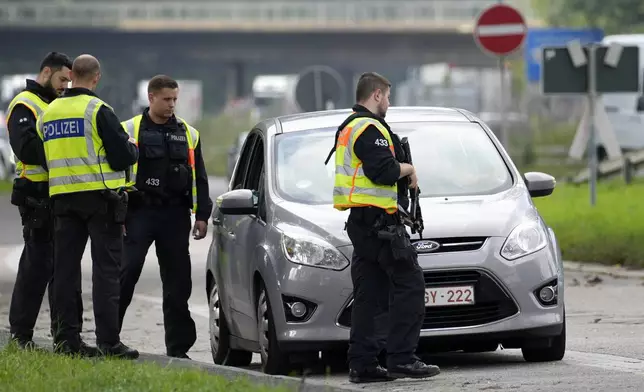 German police check the details of a driver of a car near the border to Belgium in Aachen, Germany, Monday, Sept. 16, 2024, as Germany begins carrying out checks at all its land borders. (AP Photo/Martin Meissner)