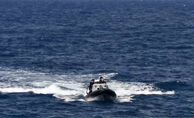 A vessel with coast guards officers takes part in a search and rescue operation after a boat carrying migrants ran into trouble off the coast of the eastern Aegean Sea island of Samos, Greece, on Monday, Sept. 23, 2024. (AP Photo/Michael Svarnias)