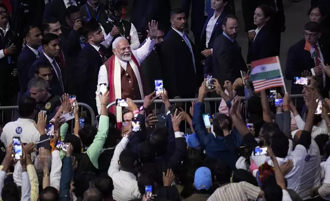 Narendra Modi, Prime Minister of India, top left, waves to the crowd after speaking at an event in Uniondale, N.Y., Sunday, Sept. 22, 2024. (AP Photo/Seth Wenig)