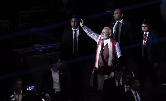 Narendra Modi, Prime Minister of India, waves to the crowd after speaking at an event in Uniondale, N.Y., Sunday, Sept. 22, 2024. (AP Photo/Seth Wenig)