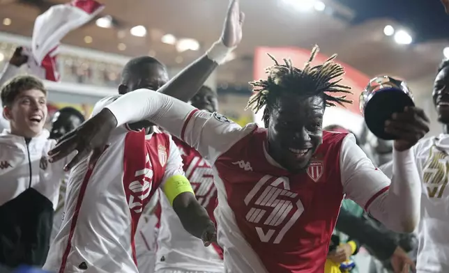 Monaco's George Ilenikhena celebrates with his teammates at the end of the Champions League opening phase soccer match against Barcelona at the Louis II stadium, in Monaco, Thursday, Sept. 19, 2024. Monaco won 2-1. (AP Photo/Laurent Cipriani)