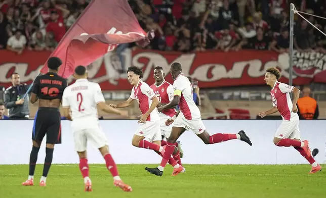 Monaco's Maghnes Akliouche, third left, celebrates after scoring his side's opening goal during the Champions League opening phase soccer match between Monaco and Barcelona at the Louis II stadium, in Monaco, Monaco, Thursday, Sept. 19, 2024. (AP Photo/Laurent Cipriani)