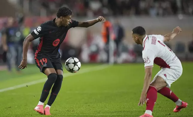 Barcelona's Lamine Yamal, left, controls the ball past Monaco's Vanderson during the Champions League opening phase soccer match between Monaco and Barcelona at the Louis II stadium, in Monaco, Monaco, Thursday, Sept. 19, 2024. (AP Photo/Laurent Cipriani)