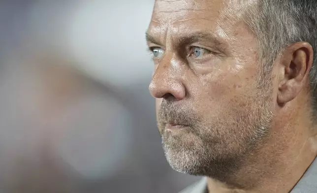 Barcelona's head coach Hansi Flick looks on prior to the start of the Champions League opening phase soccer match between Monaco and Barcelona at the Louis II stadium, in Monaco, Monaco, Thursday, Sept. 19, 2024. (AP Photo/Laurent Cipriani)