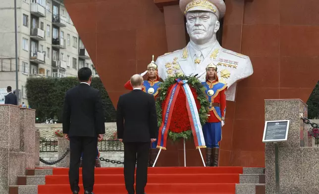 Russian President Vladimir Putin, on carpet front right, and Mongolian President Ukhnaagiin Khurelsukh, on carpet front left, attend a wreath-laying ceremony at the monument to Soviet Marshal Zhukov in Ulaanbaatar, Mongolia, Tuesday, Sept. 3, 2024. (Vyacheslav Prokofyev, Sputnik, Kremlin Pool Photo via AP)