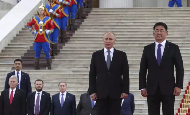 Russian President Vladimir Putin and Mongolian President Ukhnaagiin Khurelsukh, right, attend a welcome ceremony in Sukhbaatar Square in Ulaanbaatar, Mongolia, Tuesday, Sept. 3, 2024. (Vyacheslav Prokofyev, Sputnik, Kremlin Pool Photo via AP)